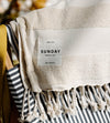 A beige towel labeled 