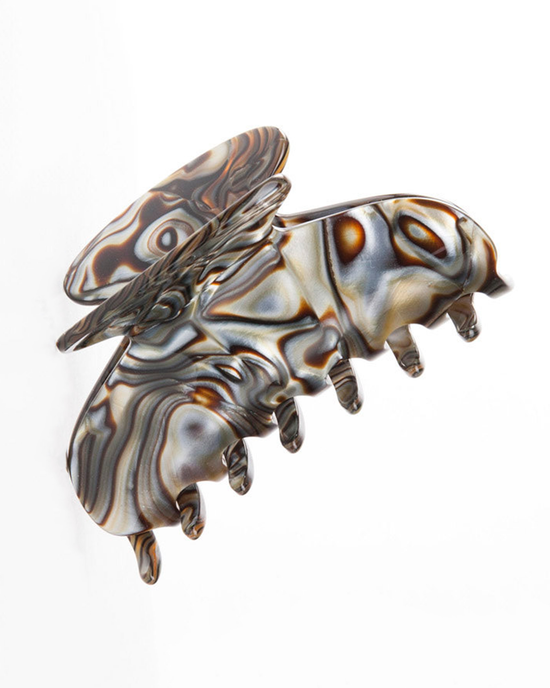 A Luxor Jaw Lrg in Onyx claw clip in the shape of a bee with a marbled pattern by Ficcare.