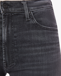 Close-up of a medium grey wash denim trouser pocket and waistband from the Mother Denim Ditcher Zip Ankle in Smoking Section.