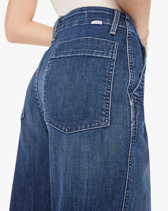 Close-up view of a Mother Major Zip Flood in Electric Souvenir high-waisted jean pocket detailing.