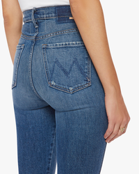 A close-up view of the back of a Mother High Waisted Dazzler Double Heel in Morning Chores denim jean showing the pocket design and waistband.