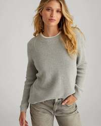 Woman posing in a 525 Emma in Medium Heather Grey ribbed crewneck sweater and casual pants.