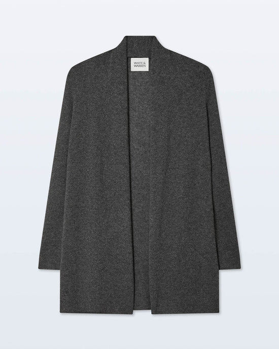 The White + Warren Cashmere Trapeze Cardigan in Dark Slate Heather is a long, collarless, open-front piece with a straight fit, shown on a light background. A white neck label with text is visible.