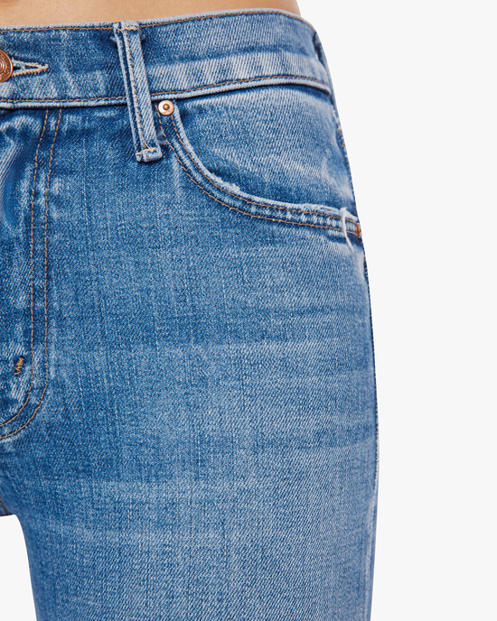 Close-up view of a person wearing The Outsider Ankle in High On The Hog jeans from Mother Denim, focusing on the pocket detail.