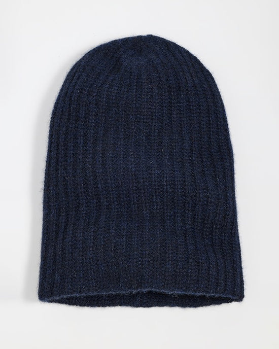 A White + Warren Cashmere Plush Rib Beanie in Deep Navy is laid flat on a plain white background.