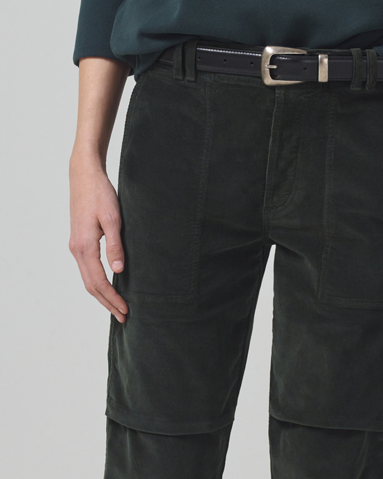Person standing with hand in pocket wearing Citizens of Humanity's Agni Utility Trouser in Seaweed Cord and a black belt.
