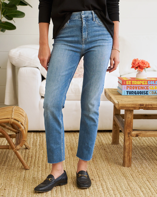 Woman standing in a casual pose wearing blue Frank & Eileen Derry Pant in 2001 Classic Blue Wash and black loafers.