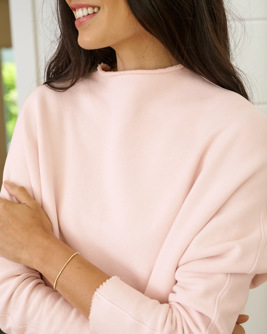 Woman in a Frank & Eileen Effie L/S Funnel Neck Capelet in Vintage Rose smiling, with her arms crossed.
