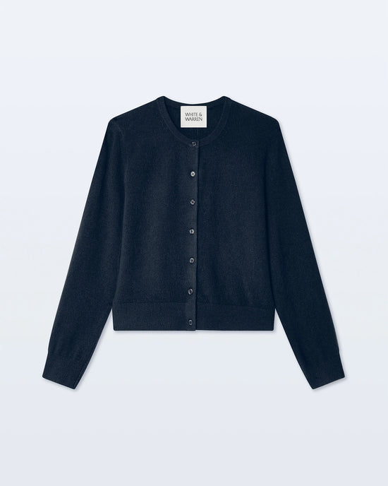 A deep navy, long-sleeve cashmere crewneck cardigan by White + Warren is displayed laid flat on a light background.