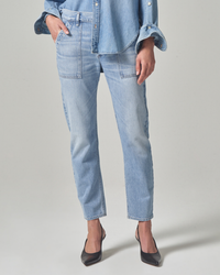 Woman wearing Citizens of Humanity Leah Cargo in Pinpoint denim jacket and relaxed fit jeans with black heels, standing against a neutral background, cropped at the waist.