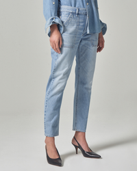 Woman wearing Citizens of Humanity Leah Cargo in Pinpoint relaxed fit jeans and black high heels, cropped view from waist to feet against a neutral background.
