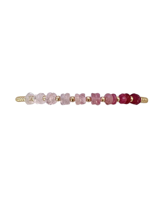 A 2MM Sig Bracelet with Pink Sugar Ombre & Yellow Gold adorned with an arrangement of pink and purple Sapphire gemstone beads by Karen Lazar Design.