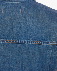 Close-up of a Mother denim jacket highlighting the texture and stitching details of The Out Of Pocket Jacket in Morning Chores.