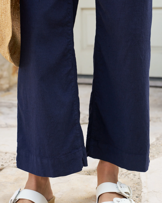 A person's legs and feet in Frank & Eileen's Wexford Trouser in Navy.