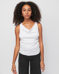 Woman in a Nation LTD Tarin Racerback Cowl in White and black jeans standing against a plain background.