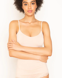 Woman posing in an Only Hearts Del Adjustable Strap Cami in Cream, arms crossed.