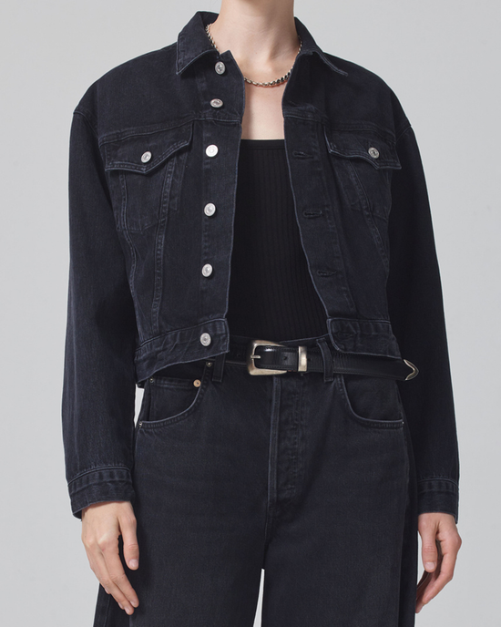 A person in a Dulce Denim Jacket in Venetia by Citizens of Humanity and jeans with a black top and a choker necklace.