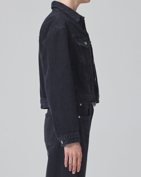 Side profile of a person wearing a Citizens of Humanity Dulce Denim Jacket in Venetia and jeans.