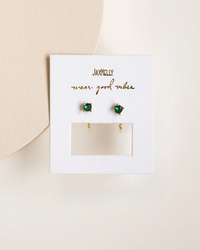 Pair of Emerald Huggies with Cubic Zirconia displayed on a white card by JaxKelly.