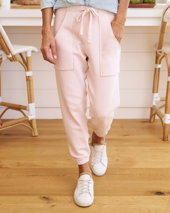 Woman standing in the kitchen wearing pink Frank & Eileen Eamon Jogger Sweatpants in Vintage Rose and white sneakers.