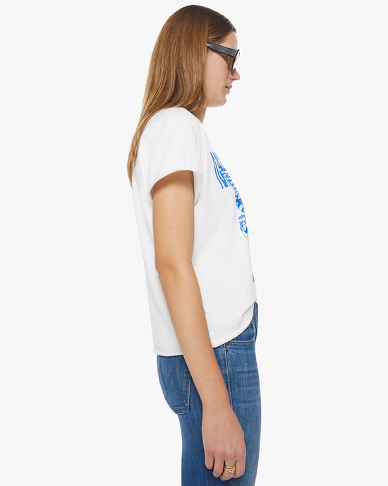 Side view of a woman wearing sunglasses, a 100% Cotton Mother Tee, and blue jeans.