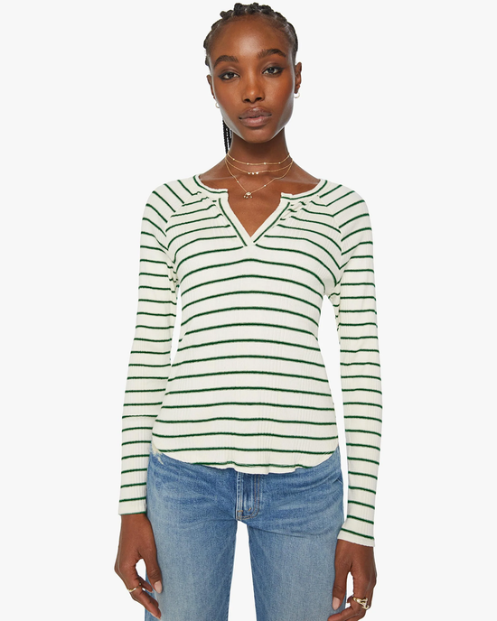 Woman wearing a Mother Split Varsity Long Sleeve in High Road Stripe crewneck sweater with blue jeans.