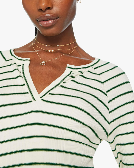 A woman wearing a Mother Split Varsity Long Sleeve in High Road Stripe accessorized with layered necklaces.