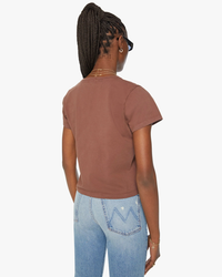 A woman from behind wearing The Boxy Goodie Goodie in Mother Sunset t-shirt and Mother Denim blue jeans, showcasing braided hairstyle and sunglasses perched on the back of her head.
