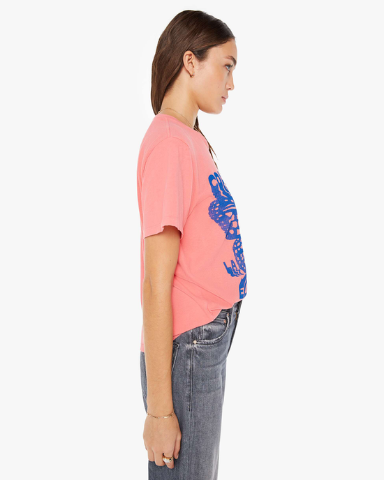 Side profile of a person wearing pink Mother Denim The Rowdy in Medusa with a blue graphic design and grey Mother Denim jeans.