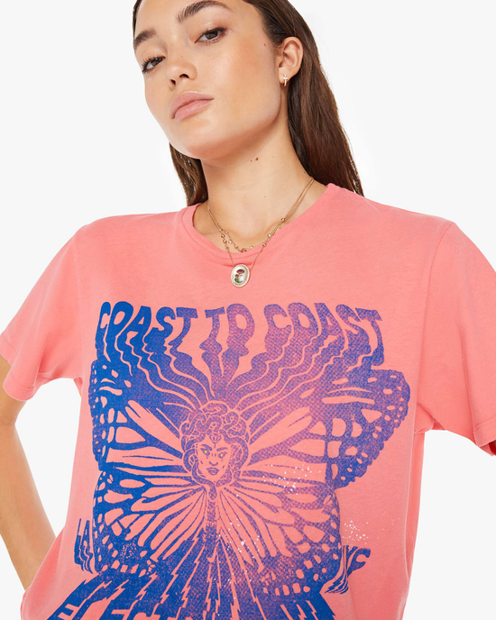 Woman in a pink Mother Rowdy Tee with a blue butterfly graphic design.