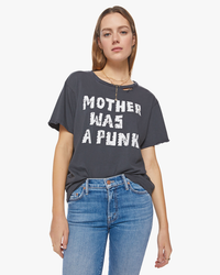 Woman in a Mother Was A Punk Tee and blue jeans.