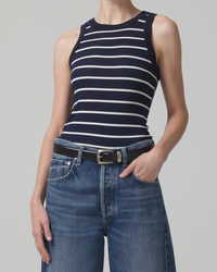 Woman wearing a Citizens of Humanity Isabel Tank in Midnight Stripe in organic cotton rib and jeans with a black belt.