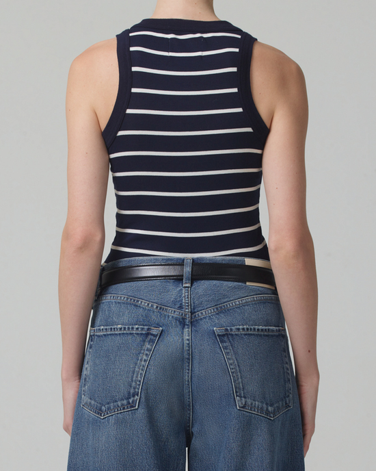 Woman wearing a Citizens of Humanity Isabel Tank in Midnight Stripe and jeans with a belt from the back view.