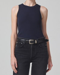 Woman wearing a blue Isabel Rib Tank in Navy made of organic cotton and black Citizens of Humanity jeans with a belt.