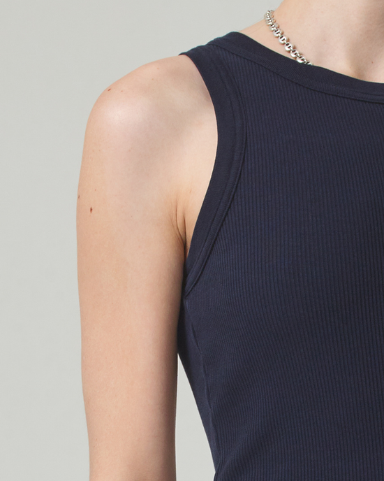 Close-up of a person in a Citizens of Humanity Isabel Rib Tank in Navy showing one shoulder and a silver chain necklace.
