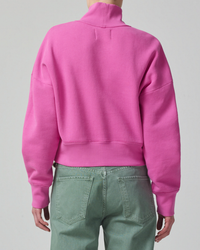 Person from behind wearing a Koya Turtleneck in Rosey by Citizens of Humanity and green jeans.