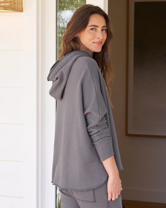 Woman standing at a doorway wearing a gray Frank & Eileen Kane Capelet Hoodie in Elephant with a relaxed fit.