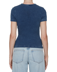 Rear view of a woman wearing a blue Arlo Rib Pocket Tee in Indigo and light blue AGOLDE denim jeans, focusing on her upper back.