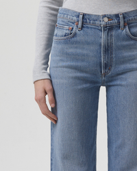 Close-up view of a person wearing AGOLDE Harper Straight Jean in Flash with a focus on the denim texture and pocket details.