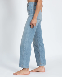 Side profile of a person wearing loose-fitting high rise wide leg Sailor Pant in Water Street by ASKK NY against a white background.