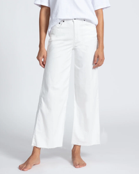 A person standing in ASKK NY Crop Wide Leg in Ivory and a white t-shirt, with feet bare.