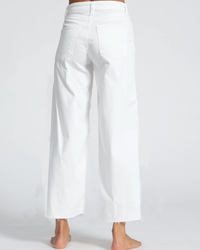 A person standing barefoot wearing ASKK NY's Crop Wide Leg in Ivory.