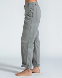 Side view of a person wearing ASKK NY's Volcano Grey low slung Chino - Twill pants against a white background.