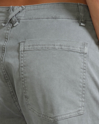 Close-up of a back pocket on gray denim jeans, made from ASKK NY Chino - Twill in Volcano Grey.