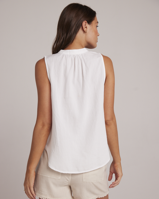 Woman wearing a white Bella Dahl Sleeveless Pullover with a Mandarin collar, viewed from behind.