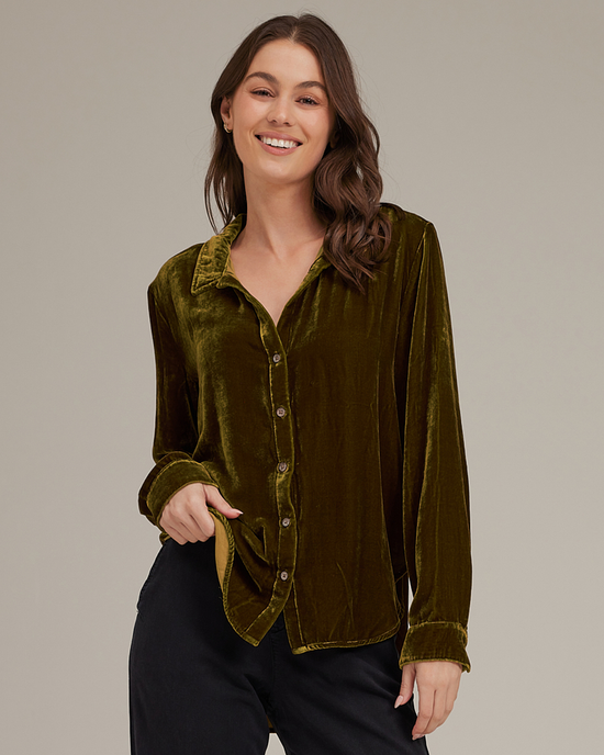 Woman smiling in a Bella Dahl Long Sleeve Clean Shirt in Olive Gold and black trousers.