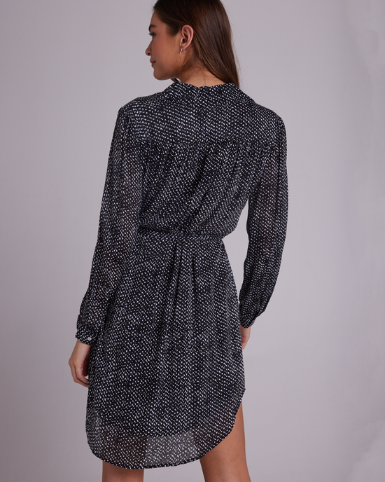A woman seen from behind wearing a Bella Dahl Belted Hidden Placket Dress in Midnight Snow Print with puffed sleeves.