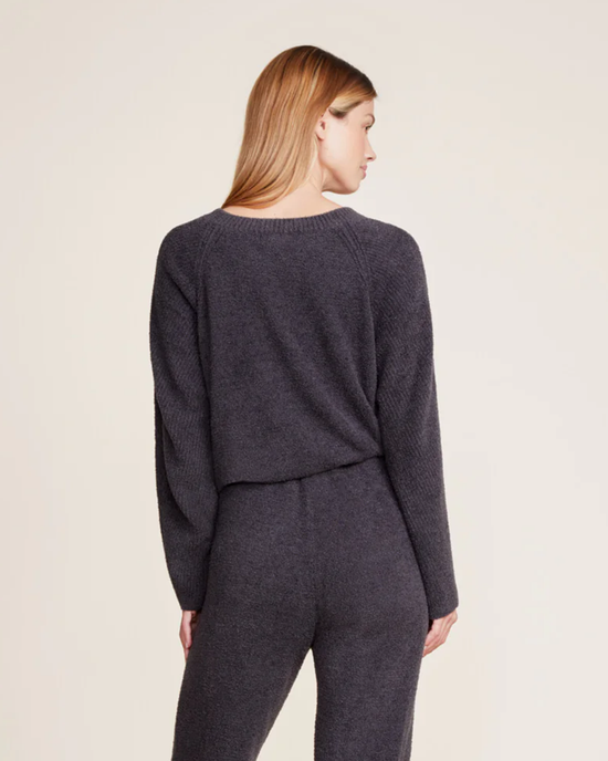 A woman facing away from the camera, wearing a dark gray CCL Rib Blocked Pullover in Carbon and matching pants by Barefoot Dreams.