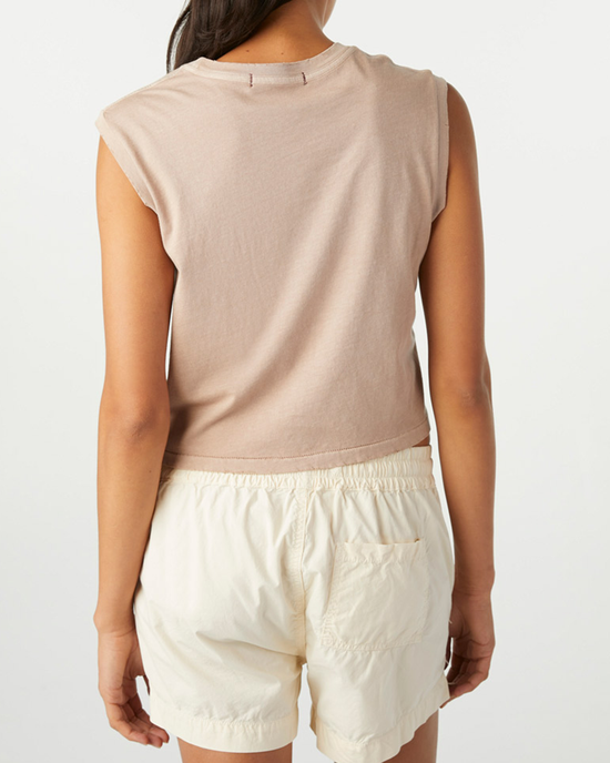 Woman seen from behind wearing a sleeveless Babe Tee in Taupe and white shorts by AMO.
