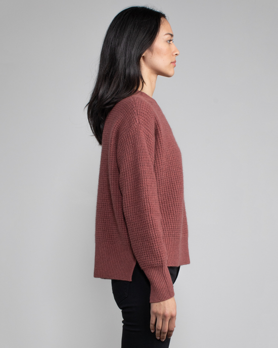Woman in profile wearing a burgundy Nora Pullover in Cinnamon cashmere sweater and black pants by Margaret O'Leary.